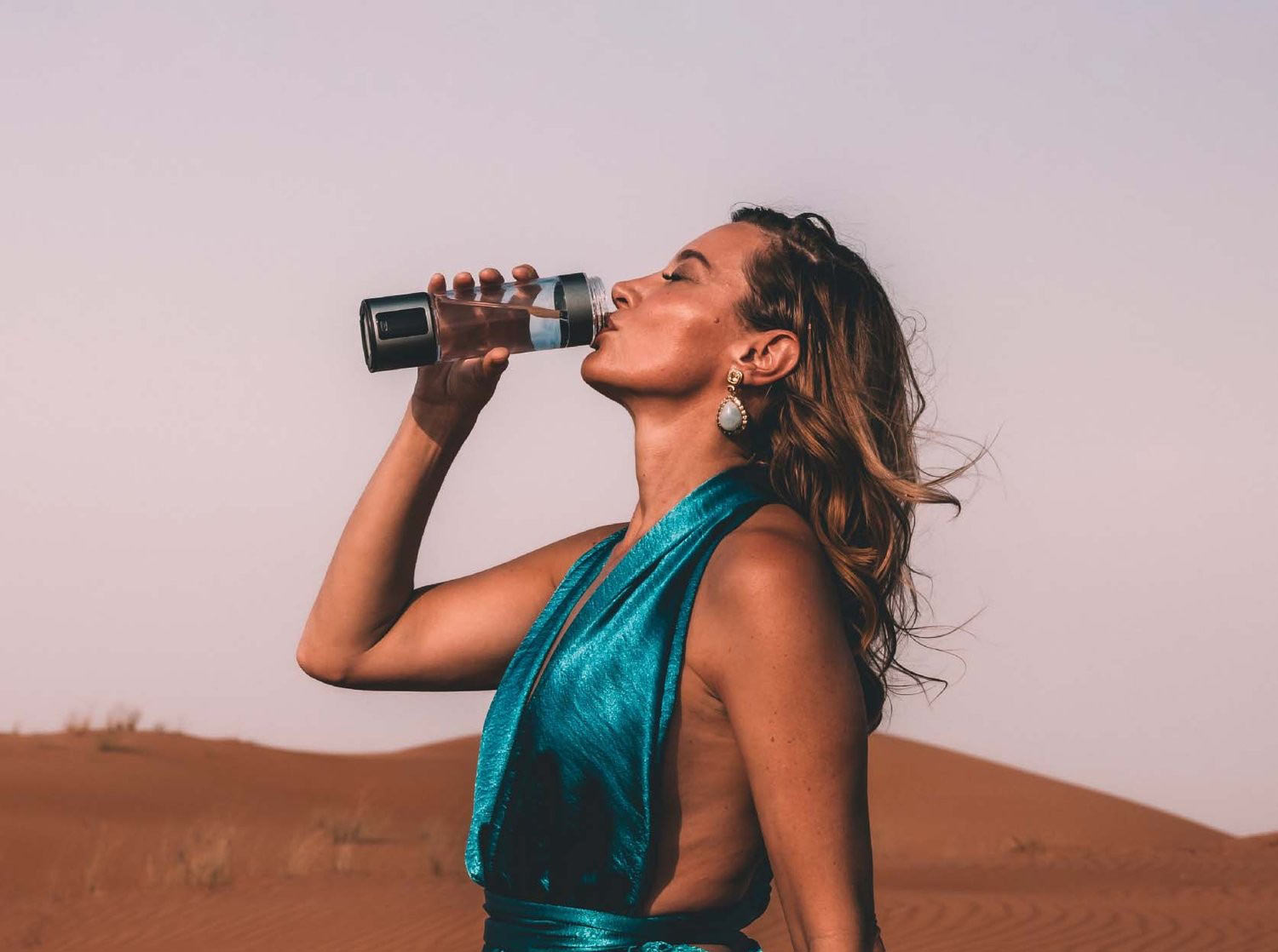 woman drinking hydrogen water with lumivitae bottle